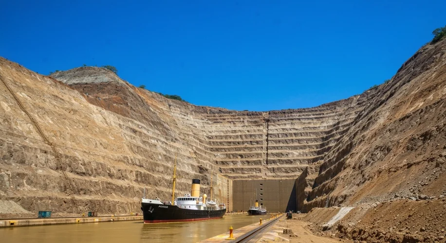 The SS Ancon passing through the Gaillard Cut of the Panama Canal, a vast excavation through a mount