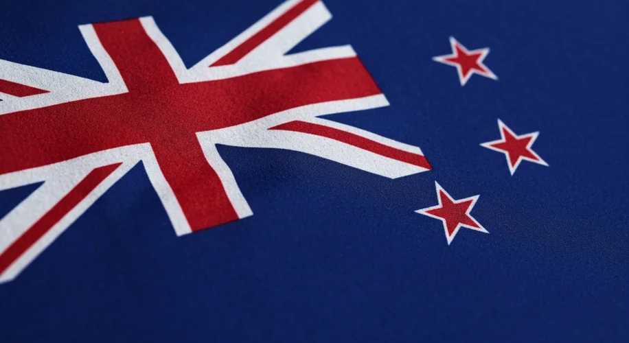 A close-up of the New Zealand flag, highlighting the detailed stitching of the Union Jack in the can