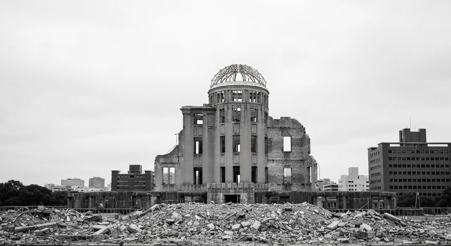 A black and white photograph showing the skeletal remains of the Hiroshima Peace Memorial (Atomic Bo