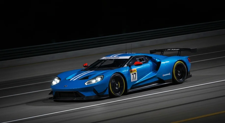A dynamic shot of the modern Ford GT (2016 onwards) racing under the lights at Le Mans, emphasizing 