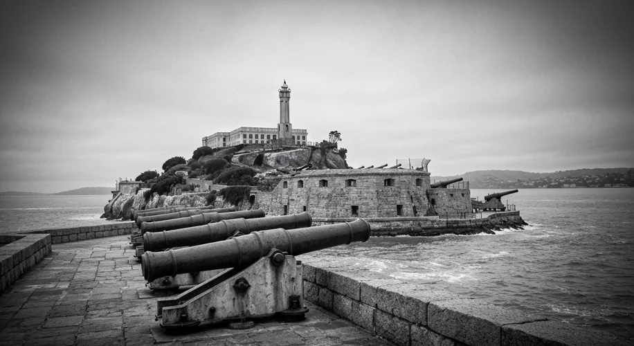 An old black and white photograph of Alcatraz Island fortress with cannons, overlooking San Francisc