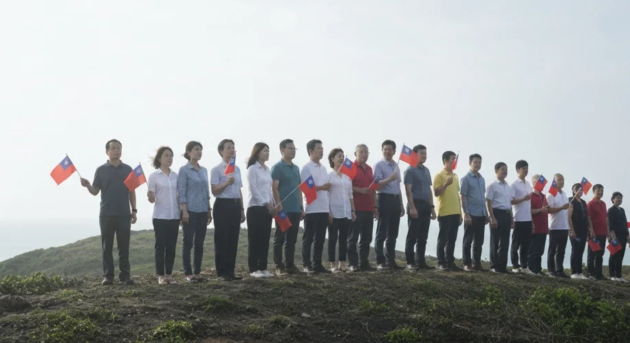 A diverse group of Taiwanese citizens holding small flags and looking towards the horizon with a det
