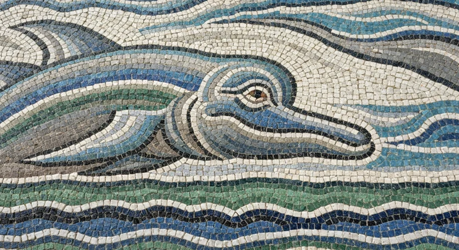 Close-up view of a section of a Roman mosaic, highlighting the tiny, irregular shapes of the tessera